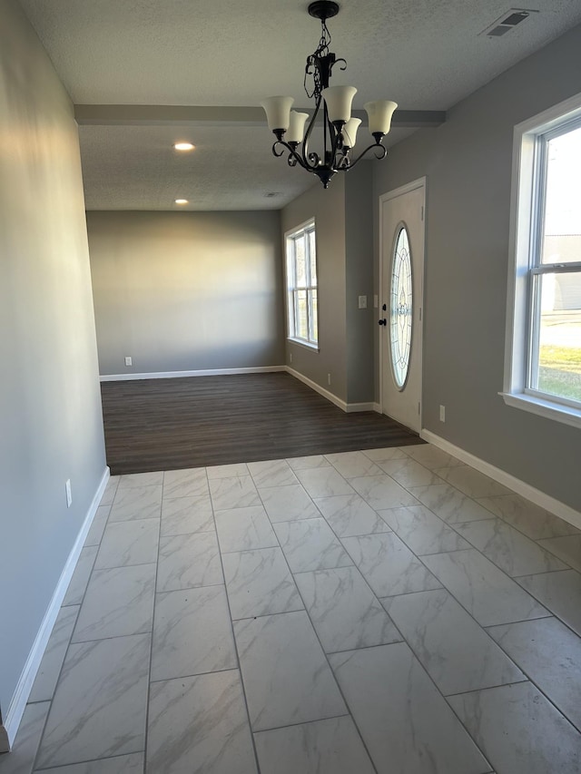 entrance foyer featuring a healthy amount of sunlight and a textured ceiling