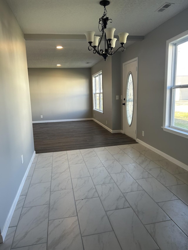 121 Poplar St N, Cowan, TN 37318 - foyer entrance featuring a textured ceiling, a chandelier, recessed lighting, and marble look tile flooring