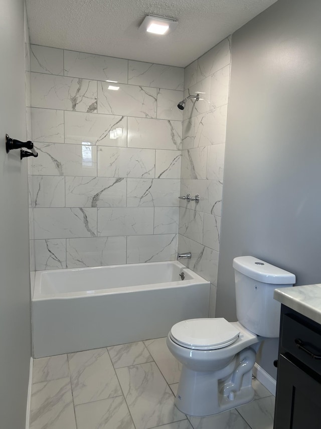 full bathroom with vanity, tiled shower / bath combo, a textured ceiling, and toilet