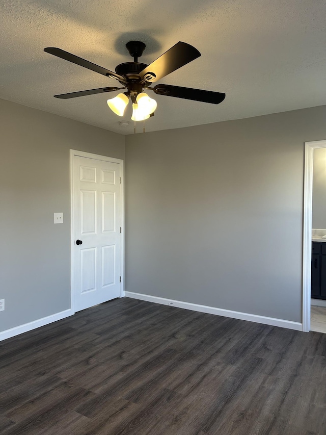 unfurnished room with a textured ceiling, dark hardwood / wood-style floors, and ceiling fan