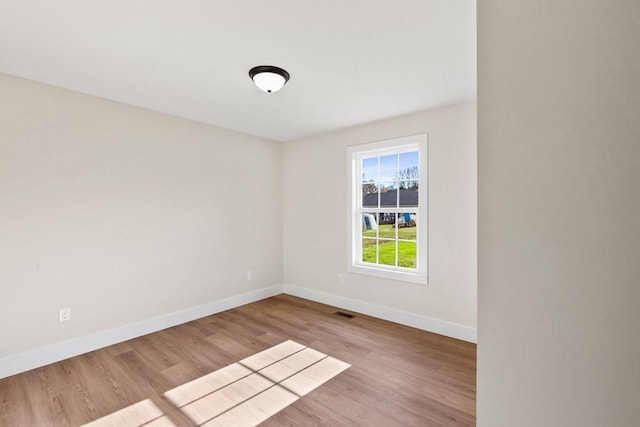 spare room featuring light wood-type flooring