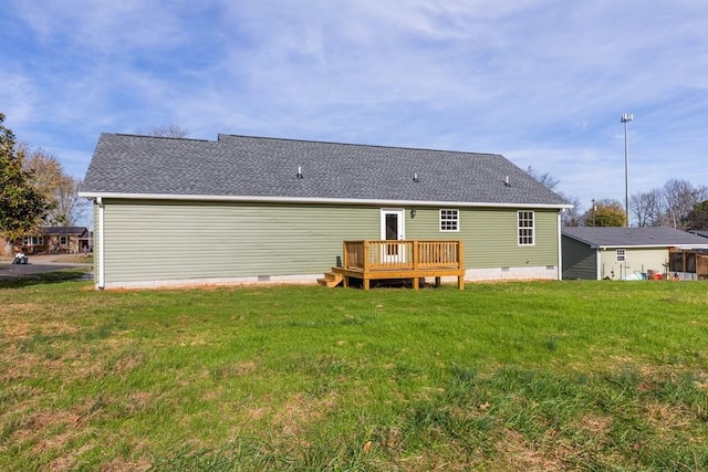 back of property with a yard and a deck