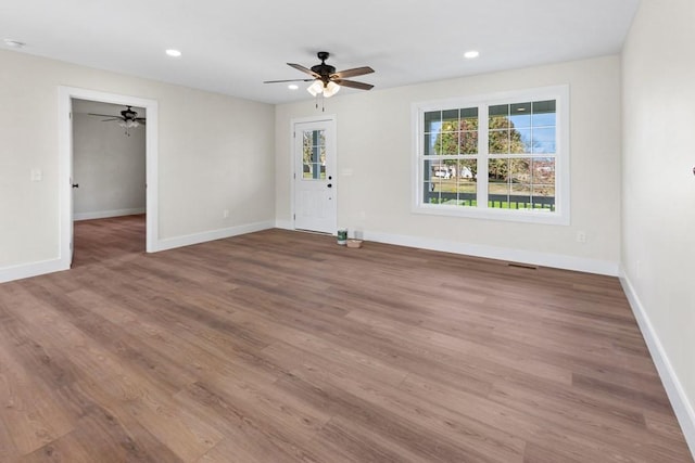 unfurnished room with wood-type flooring and ceiling fan