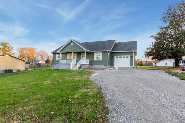 ranch-style house featuring a garage, central AC unit, covered porch, and a front lawn