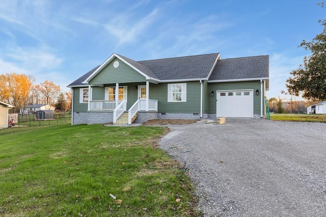 single story home with a garage, a front yard, and a porch