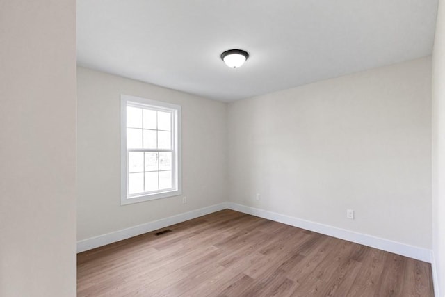 spare room with light hardwood / wood-style floors