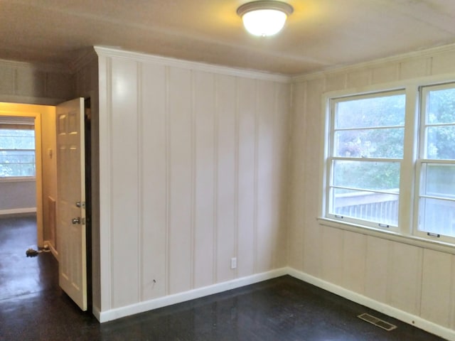 empty room featuring ornamental molding