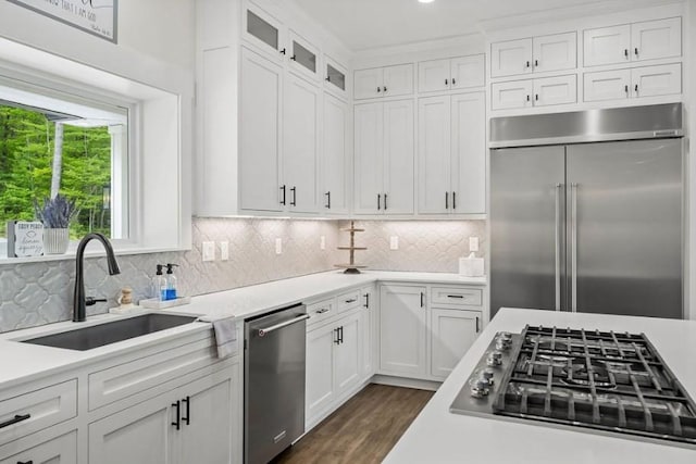 kitchen featuring white cabinets, decorative backsplash, sink, and appliances with stainless steel finishes