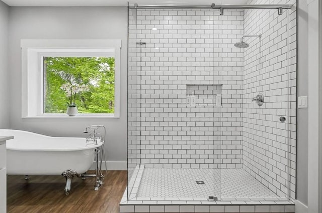 bathroom featuring hardwood / wood-style flooring and separate shower and tub