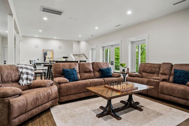 living room with french doors and hardwood / wood-style flooring