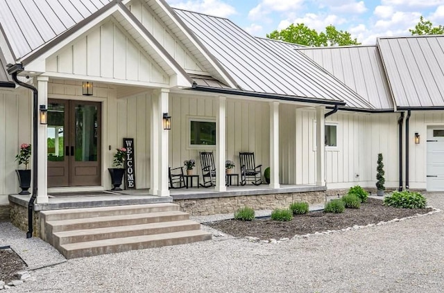 entrance to property featuring a porch and a garage