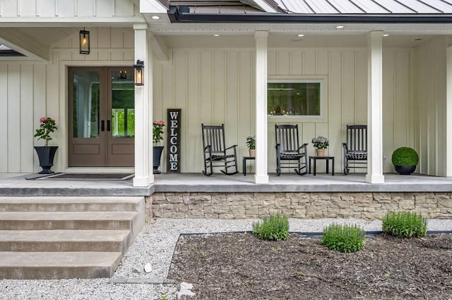 view of exterior entry featuring a porch and french doors