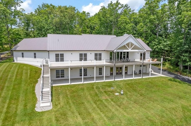 back of property featuring a yard and a deck