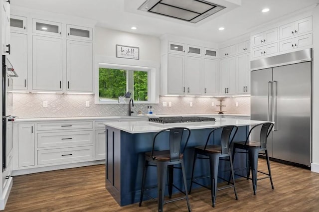 kitchen with a kitchen island, white cabinets, and appliances with stainless steel finishes