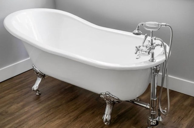 bathroom featuring a washtub and hardwood / wood-style flooring