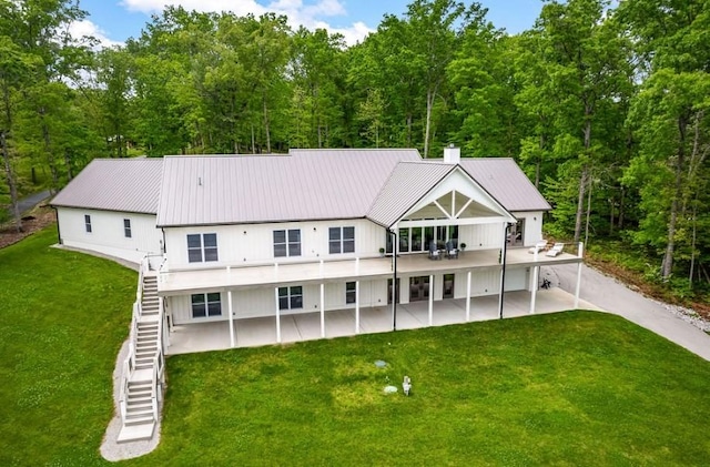 rear view of property featuring a yard