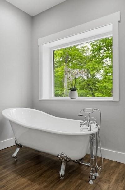 bathroom featuring a tub to relax in and hardwood / wood-style flooring