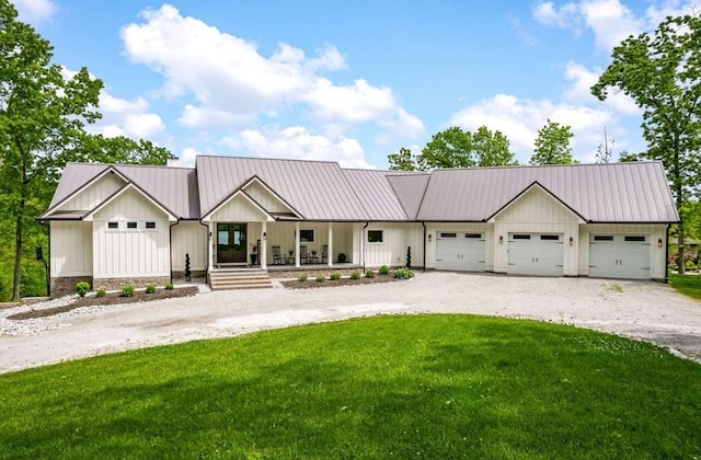 view of front of home featuring a front lawn, covered porch, and a garage