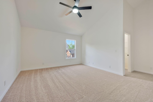 carpeted spare room with high vaulted ceiling and ceiling fan