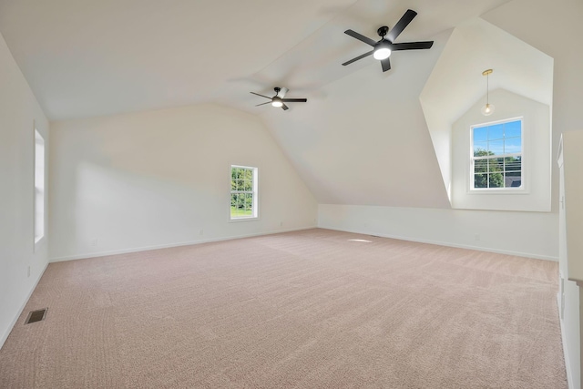 bonus room with plenty of natural light, ceiling fan, and vaulted ceiling