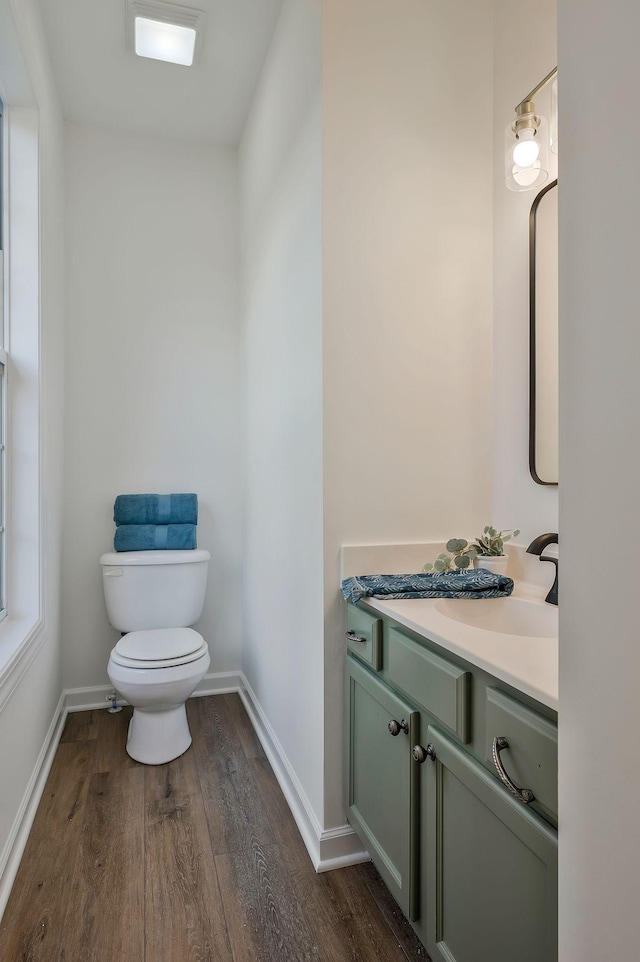 bathroom with vanity, toilet, and wood-type flooring