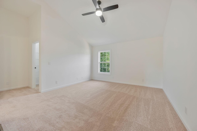 carpeted spare room featuring high vaulted ceiling and ceiling fan