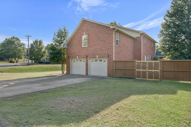 view of home's exterior featuring a yard and a garage