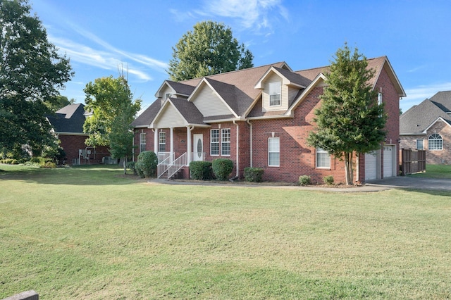 view of front of property featuring a front yard and a garage