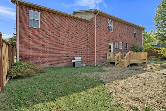 back of house with a yard and a wooden deck