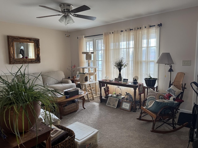 carpeted living room with ceiling fan