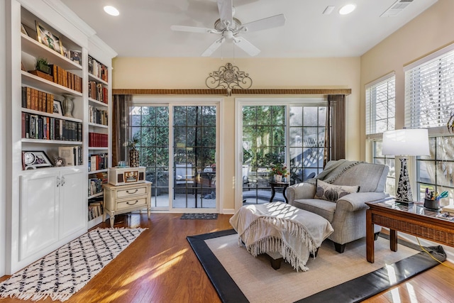 sitting room with wood-type flooring and ceiling fan