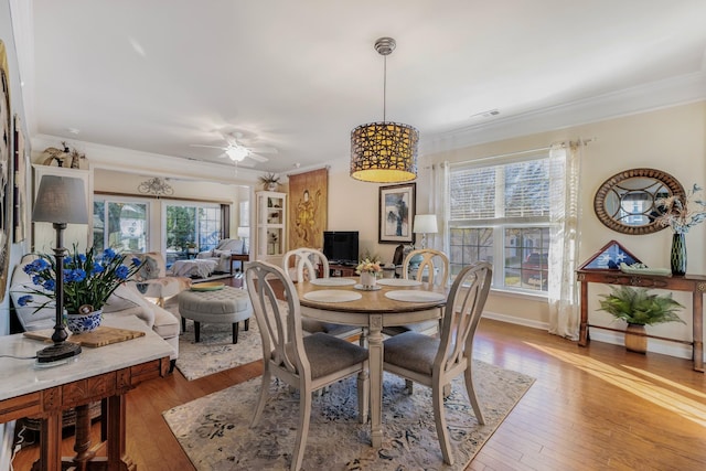 dining space with a wealth of natural light, light hardwood / wood-style flooring, and ceiling fan