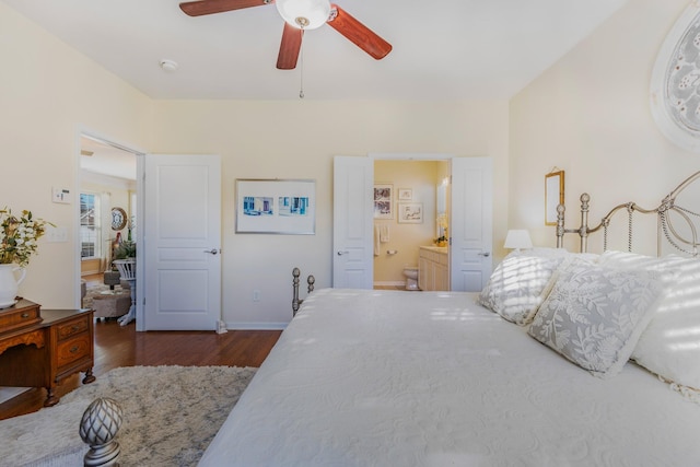 bedroom with connected bathroom, ceiling fan, and dark wood-type flooring