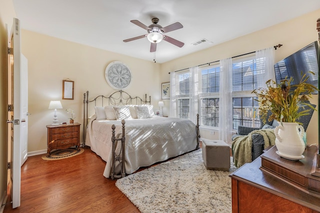 bedroom with ceiling fan and dark wood-type flooring