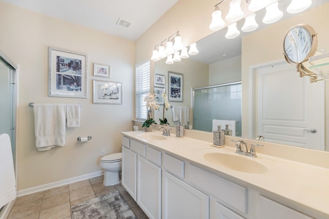 bathroom with vanity, a shower with door, an inviting chandelier, tile patterned flooring, and toilet