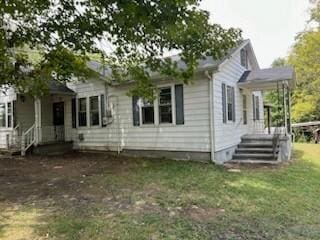 rear view of house with a lawn