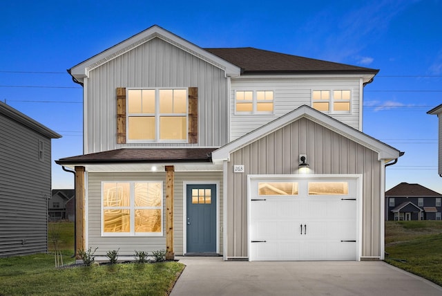 view of front of home with a front yard and a garage