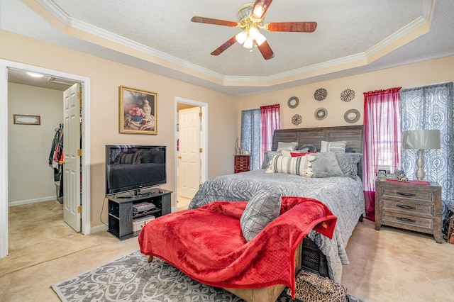 bedroom featuring ceiling fan, a tray ceiling, and multiple windows