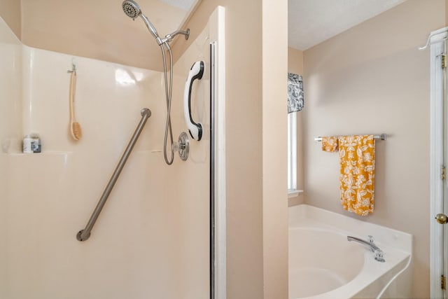 bathroom with separate shower and tub and a textured ceiling