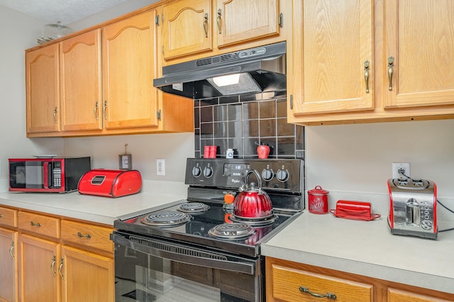 kitchen featuring decorative backsplash and electric range