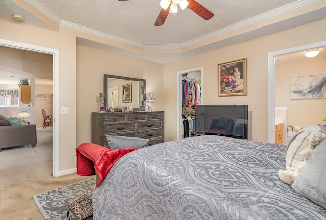 bedroom with carpet flooring, ceiling fan, a textured ceiling, a walk in closet, and a closet