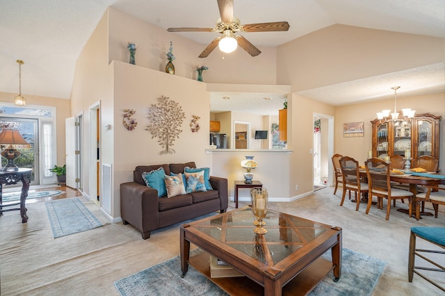 carpeted living room featuring high vaulted ceiling and ceiling fan with notable chandelier