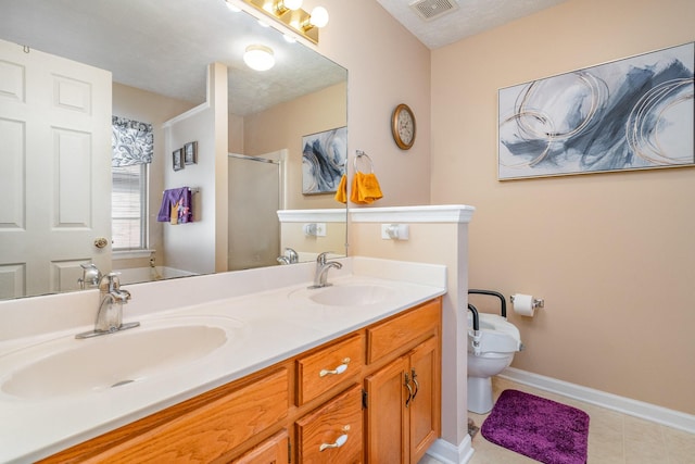 bathroom featuring tile patterned floors, vanity, a shower with shower door, and a textured ceiling