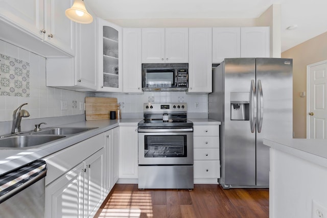 kitchen featuring dark wood-type flooring, white cabinets, and stainless steel appliances