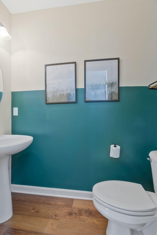 bathroom featuring hardwood / wood-style floors and toilet