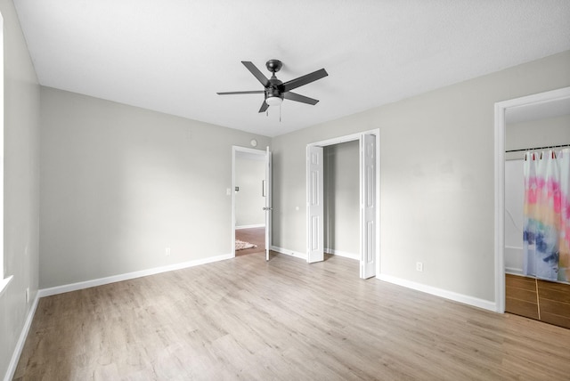 unfurnished bedroom with ceiling fan, light hardwood / wood-style floors, and a closet