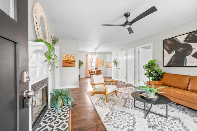 living room featuring dark hardwood / wood-style floors and ceiling fan