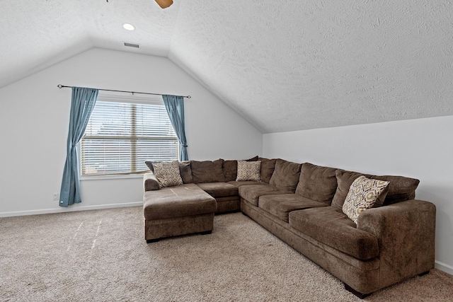 carpeted living room with lofted ceiling, a textured ceiling, a ceiling fan, visible vents, and baseboards