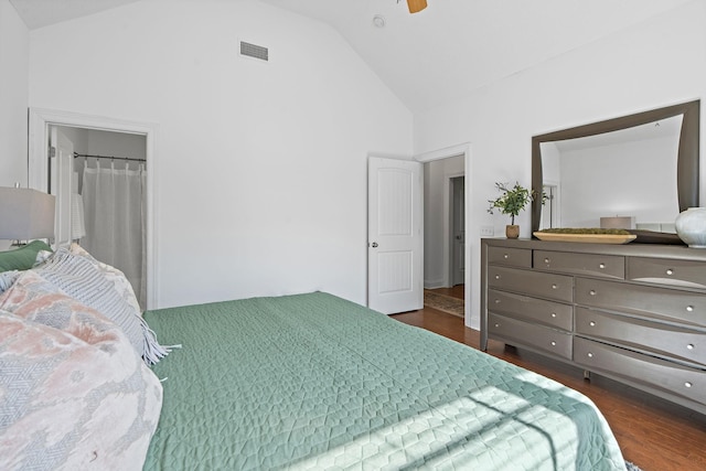 bedroom with dark wood-style floors, high vaulted ceiling, visible vents, and a ceiling fan