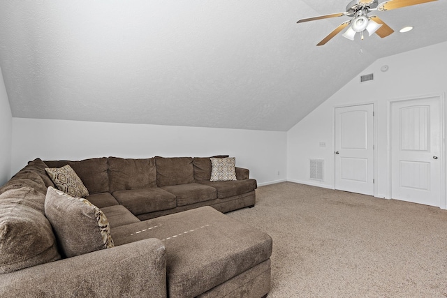 living area with carpet floors, visible vents, vaulted ceiling, and a ceiling fan